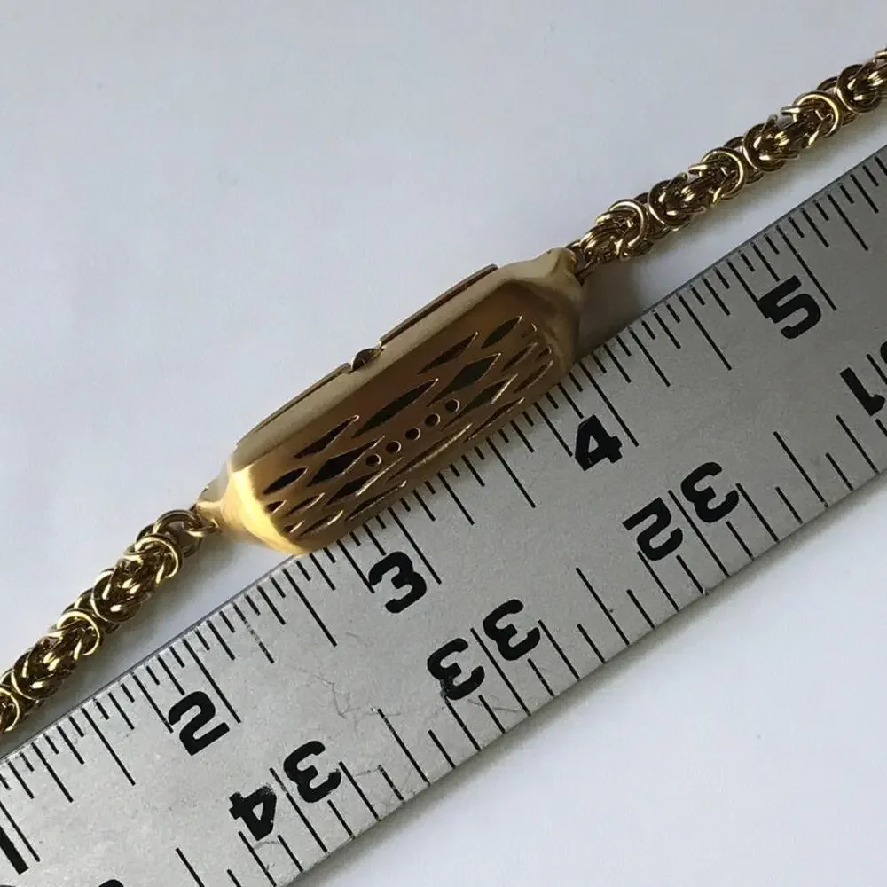 Brushed gold tone bracelet w/ a compartment for a fitbit device